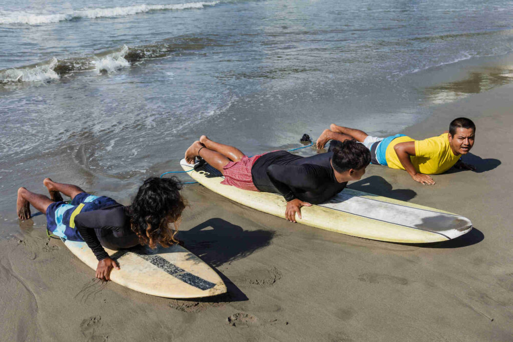 Kids Practicing Sufring Kids getting ready for surfing lesson Brasilito Tour